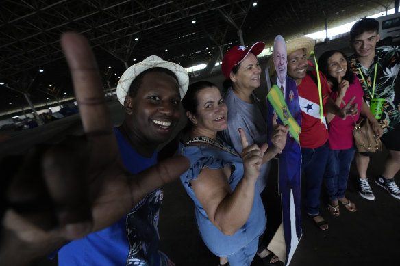 Supporters make an “L” of Lula hugging a replica of Brazilian President-elect Luiz Inacio Lula da Silva, in a camp of supporters of the president-elect, in Brasilia on December 31.