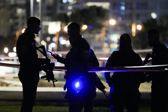 Israeli police stand at the scene of the attack in Tel Aviv. It followed three days of violence and exchange of rockets between Israel, Gaza and southern parts of Lebanon.
