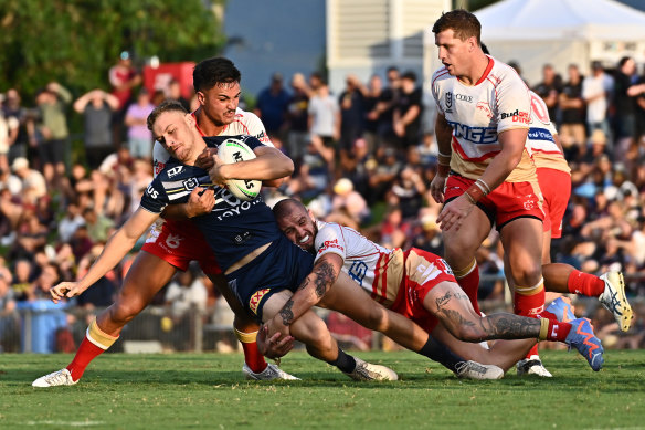 Ray Stone of the Dolphins tackles the Cowboys’ Zac Laybutt during their NRL Trial Match at Barlow Park in Cairns on Sunday.