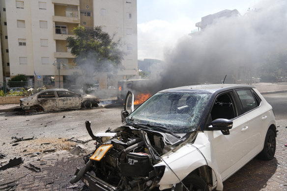 Cars on fire after they were hit by rockets in Ashkelon, Israel.