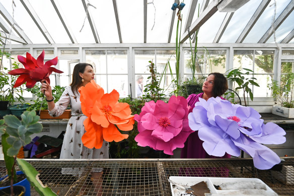 Lisa Tatman and artist Jo Neville instsalling paper flowers in the Balmain Glasshouse.