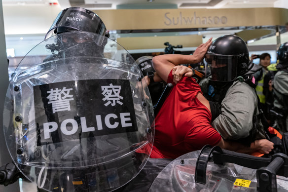 A man is detained by riot police during a demonstration in a shopping mall at Sheung Shui district on December 28. Protesters have been targeting commercial centres during the Christmas period.