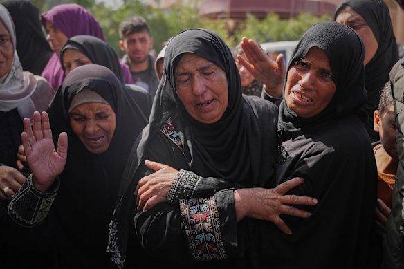 Palestinians mourn during the funeral of Reem al-Akhras, who was killed while heading to an aid distribution hub, in Khan Younis on Tuesday.