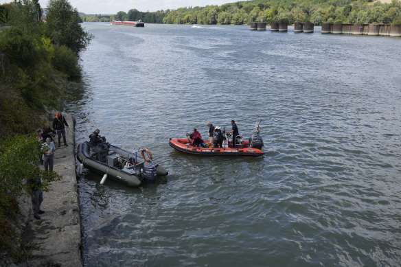 A French fire brigade tracks the whale in the Seine by boat. 