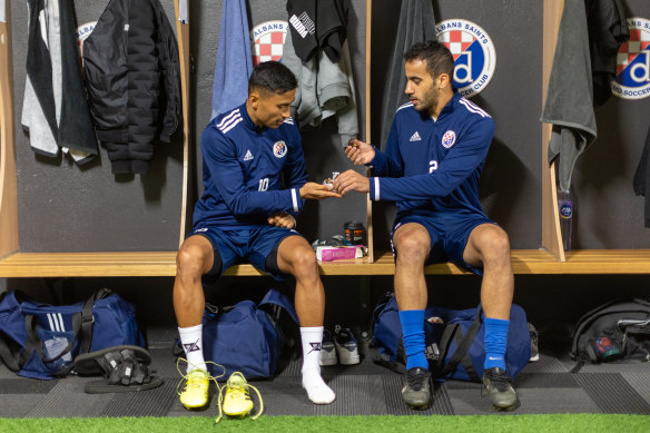 Zelfy Nazary (left) and Hakeem al-Araibi (right) share dates after sunset.