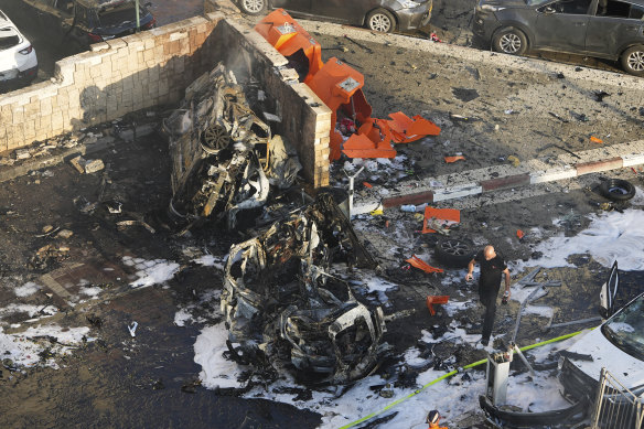 Israeli firefighters extinguish fire after a rocket fired from the Gaza Strip hit a parking lot in Ashkelon.
