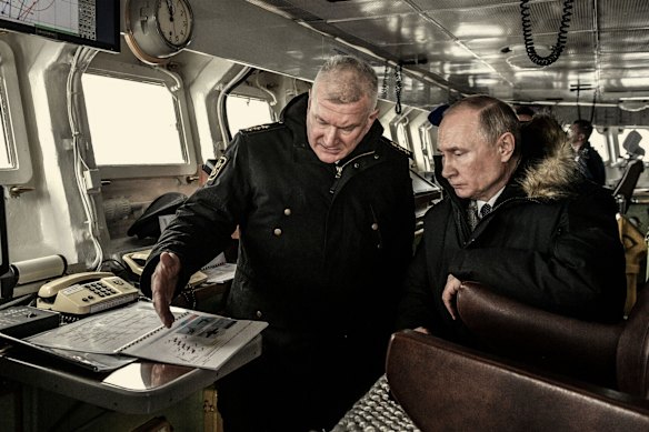 Russian President Vladimir Putin  (right) during a naval exercise from the Marshal Ustinov missile cruiser in the Black Sea in 2020. 