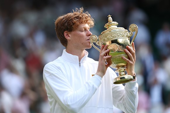 Jannik Sinner kisses the famous trophy.
