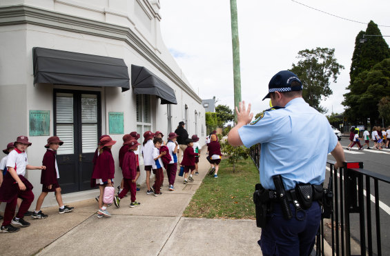 Students from Willoughby Public School return to school on Tuesday afternoon after being evacuated when the adjacent high school received threatening emails.