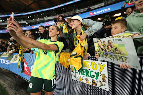 Alanna Kennedy of Australia poses for a selfie with fans.