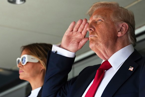 US President Donald Trump, right, salutes alongside first lady Melania Trump as they attend the Club World Cup final soccer match in New Jersey on Sunday.