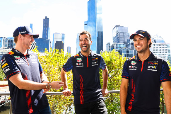 Ricciardo with Max Verstappen and Sergio Perez in a Red Bull team photo.