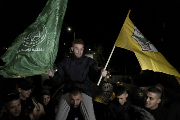 A Palestinian man is carried on the shoulders after being released from prison by Israel, in the West Bank town of Ramallah.