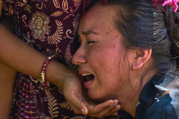 A girl cries as she waits for news of relatives missing in Bidur in Nepal’s Nuwakot district.