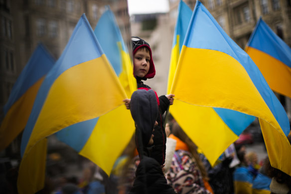 Supporters of Ukraine wave the nation’s yellow and blue flag during a protest against Russia’s invasion in Istanbul, Turkey.