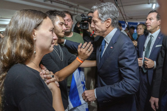 US Secretary of State Antony Blinken greets Lior Gelbaum (left), a dual US-Israeli citizen, and her boyfriend Klil Valiano.