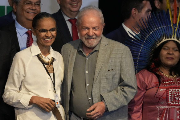 Re-elected Brazilian President Luiz Inacio Lula da Silva and his newly-named Environment Minister Marina Silva, left, smile during a meeting where he announced the ministers for his incoming government, in Brasilia, on the eve of his inauguration. On his right is Sonia Guajajara, minister for indigenous peoples.