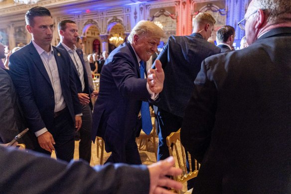 Former president Donald Trump greets guests watching the midterm elections at his Mar-a-Lago residence in Florida.