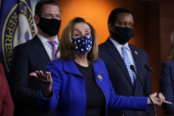 House Speaker Nancy Pelosi with impeachment managers Eric Swalwell and Joe Neguse.