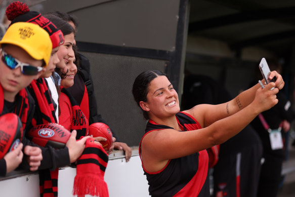 Maddy Prespakis takes a selfie with Bombers fans after Essendon’s win over St Kilda.