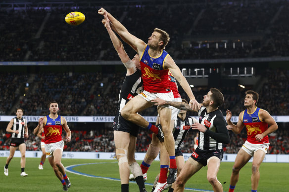 Brisbane’s Harris Andrews spoils Collingwood’s Darcy Cameron from marking on Friday night.