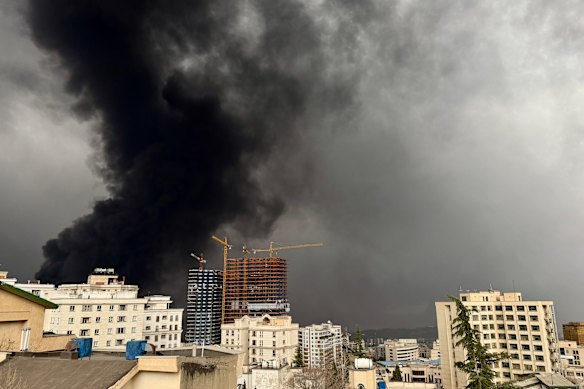 Smoke billows after airstrikes on oil depots on March 8, 2026 in Tehran, Iran. 