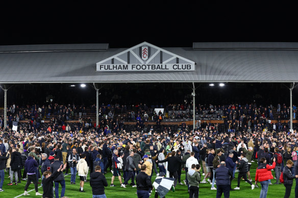 Fulham fans invade the pitch to celebrate their promotion back to the EPL