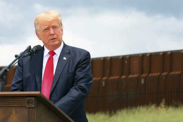 Donald Trump speaks at his beautiful wall between the US and Mexico in June.