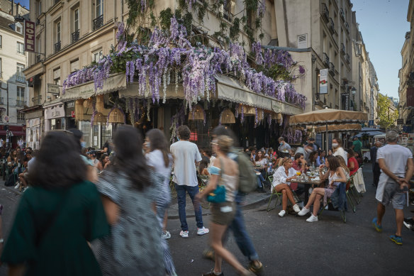 Packed cafes and restaurants on the Rue de Buci in Paris on Sunday.