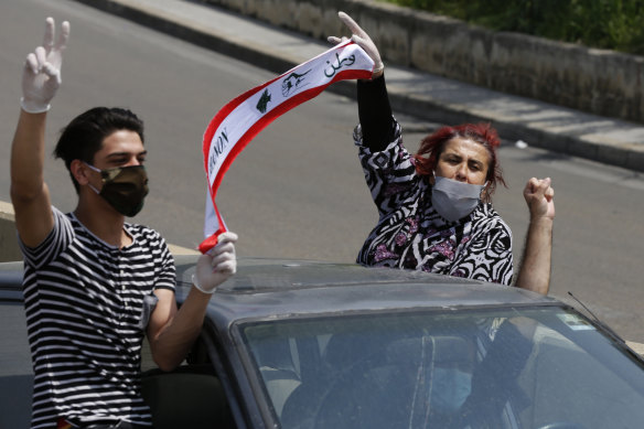 Anti-government protesters drive in a convoy through the streets of Beirut.