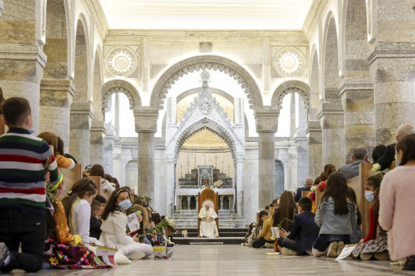 Pope Francis, centre, meets with the Qaraqosh Christian community at the rebuilt Church of the Immaculate Conception.