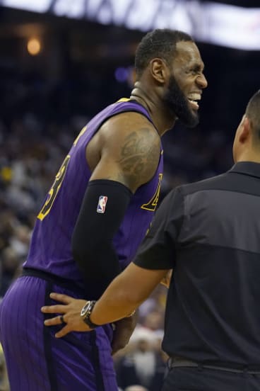 LeBron James grimaces after straining his groin.