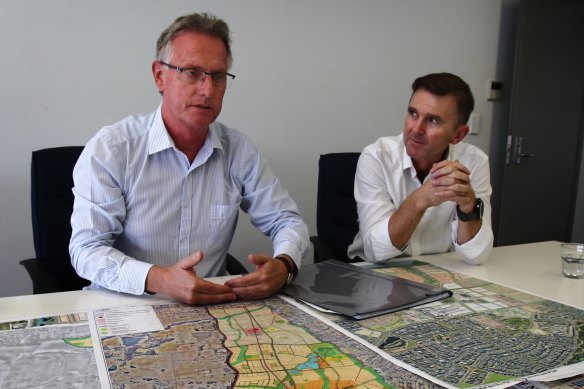 Greenfields Development Company's Mark Perich (right) and Mick Owens with maps showing the rapid development in the south-western suburbs. 