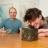QUT PhD researcher Carl Walsh, right,  with Professor Balz Kamber and a sample of the type of rock used in their modelling.