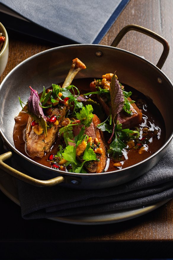 Roast duck fesunjun with butter-roasted walnuts, pomegranate and fragrant herbs.