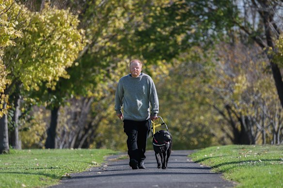 Phillip Chalker, who, in his words is "totally blind”, with  assistance dog Donna. Chalker's previous dog, Sally, had to be retired after she was attacked twice by other dogs. He started a petition calling for attacks on service dogs to be treated with greater seriousness.