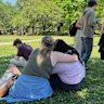 People comfort each other at Florida State University in Tallahassee, following Thursday’s shooting.