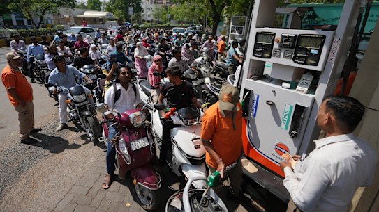 Motorists queue up to get fuel at a pump in Ahmedabad, India, this week.