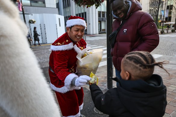 Hiroyuki Wada dresses as Santa and drives his 1959 Cadillac around the Marunouchi area of Tokyo to give presents to children. Christmas is not a national holiday in Japan, but many people still enjoy the festivities.