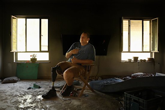 Avida Bahar, who lost his right leg after being shot by Hamas, sits in his home where his wife, Dana, and son, Carmel, were killed and daughter, Hadar, was wounded by Hamas during the October 7 attack on Kibbutz Be’eri.