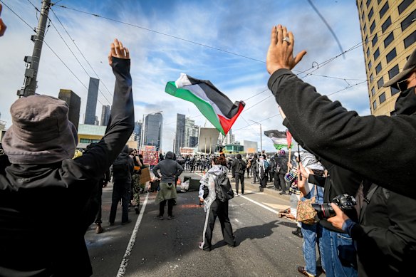 Protesters wave a Palestinian flag.