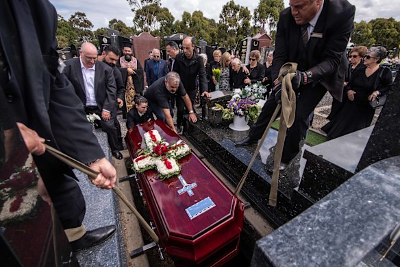 Paul’s coffin is lowered into the ground at Northern Memorial Park in Glenroy, to rest next to his son Stephen.