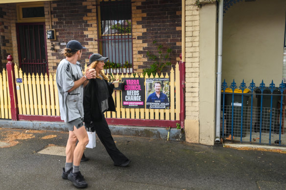 City of Yarra residents walk past Stephen Jolly’s local election posters.