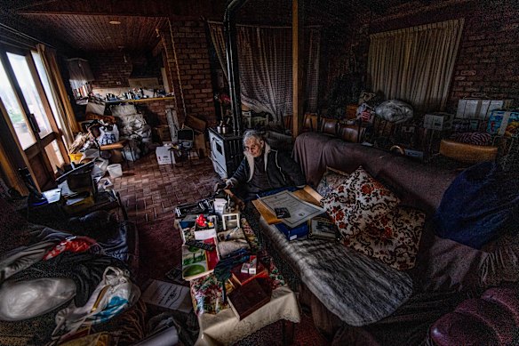 Effie in her home, surrounded by possessions, as she prepares to move out.