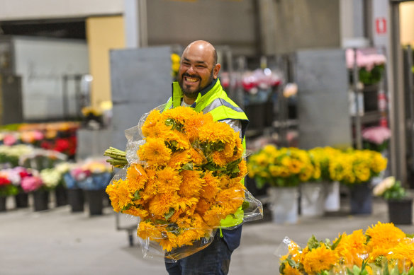 Florists arrive in the dark to pick their flowers for the day.