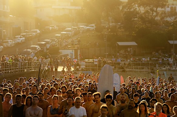 People listen to speeches before the paddle-out for Bondi terror victims. 