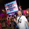 A parade participant at the Sydney Gay and Lesbian Mardi Gras Festival 2025 holding up a sign saying: “Protect trans + nonbinary kids!”