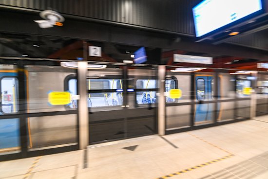 A test train at Arden Station, one of five new stations along the Metro Tunnel, passes by the platform screen doors.