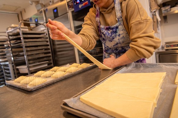 Once the pastry is measured and cut, it’s shaped into croissants.