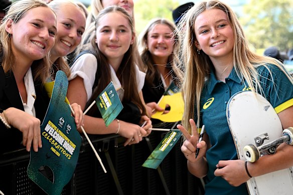 Ruby Trew poses for a photo with schoolchildren at Tumbalong Park on Friday.